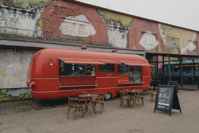 a red trailer parked outside a building